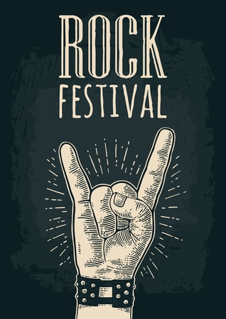 Rock and Roll sign. Hand with metal spiked bracelet giving the devil horns gesture. Vector monochrome vintage engraved illustration. Isolated on dark background. For festival posterのイラスト素材
