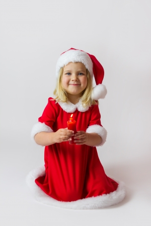 Happy girl in a red new year costumeの写真素材