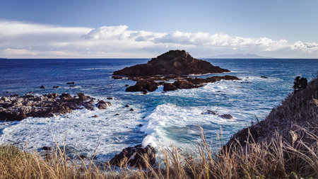 This view of Tsumeki Island, as seen from the bluff atop Cape Tsumeki, also shows Oshima Island in the distance, which approximately 35 km (21.6 mi) offshore from where I took this shot.の写真素材