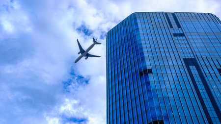 As a jet makes its approach to Haneda Airport, it passes over Tokyoâs rapidly transforming skyline seen here with the newly completed Link Pillar One North Tower standing tall beside the recently opened Takanawa Gateway Station in Minato Ward.の写真素材