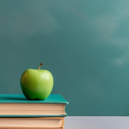Green apple and books on blackboard background. Back to school conceptの素材