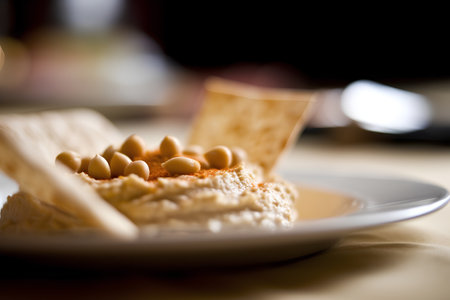 Hummus with pine nuts on a plate. Selective focus.の素材