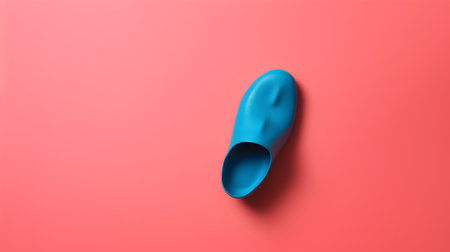 Blue rubber slippers on a pink background. Minimal concept.の素材