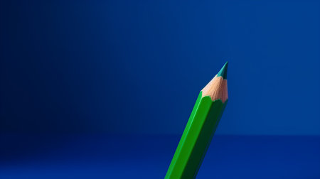 Green pencil on a blue background. Close-up. Selective focus.の素材