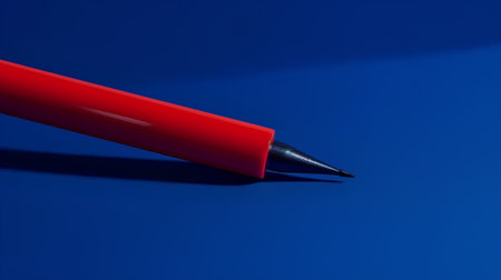 Red pen on a blue background, close-up, business conceptの素材