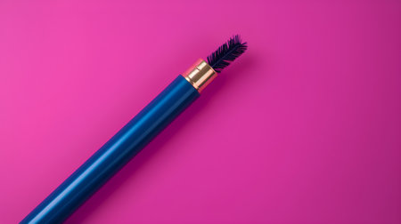 Blue mascara brush isolated on pink background. Minimalism concept.の素材