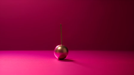 3d rendering of a golden ball with a needle on a pink backgroundの素材