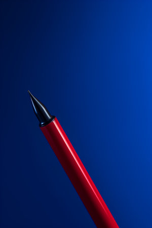 Red pen on a blue background with copy space. 3d renderingの素材