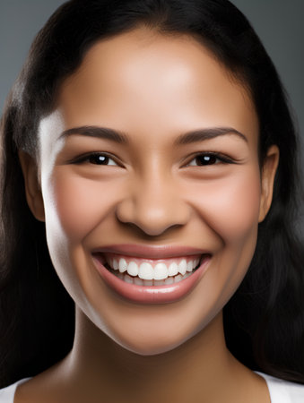 close up portrait of smiling african american woman with white teethの素材