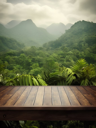 Wooden table top on green forest background for product display montageの素材