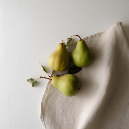 Ripe pears on a white tablecloth, top view.の素材