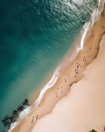Aerial view of beautiful sandy beach with turquoise sea and surfers. Drone photography.の素材