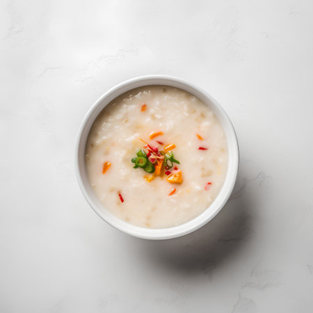 Thai style rice porridge in white bowl on white background.の素材