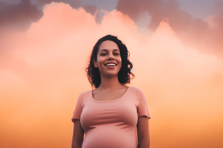 Portrait of a beautiful young woman in a pink dress against the sky with cloudsの素材