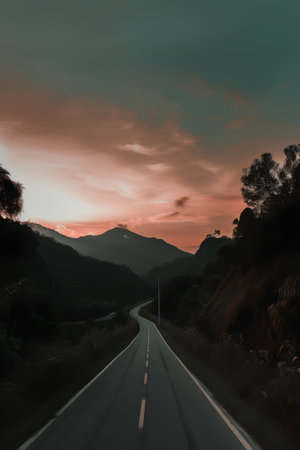Asphalt road in the mountains at sunset. Nature landscape background.の素材