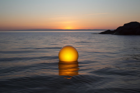 Sunset in the sea with a golden ball in the water.の素材