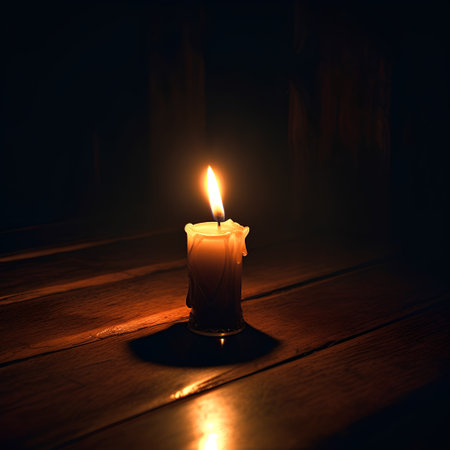 Burning candle on a dark wooden background. Selective focus.の素材
