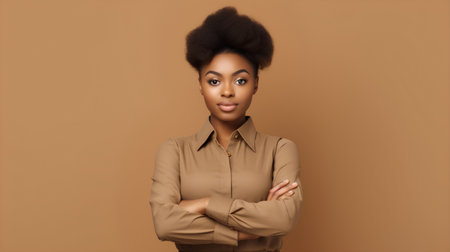 Young african american businesswoman with crossed arms on brown backgroundの素材