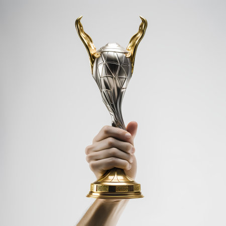 Hand holding golden trophy cup isolated on white background. 3d renderingの素材