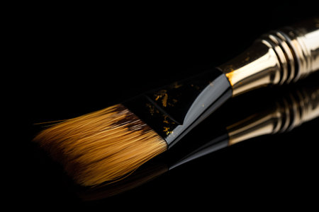 Paint brush on a black background with reflection. Close-up.の素材