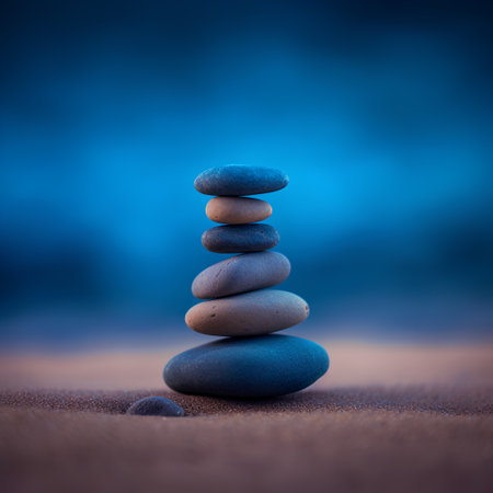 Stack of zen stones on the sand at sunset. Zen conceptの素材