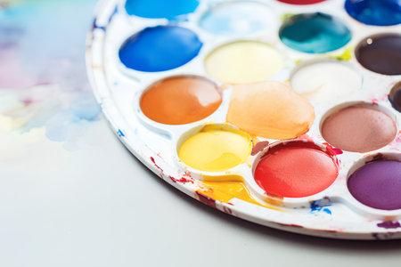 Palette with watercolor paints on a white background. Close-up.の素材