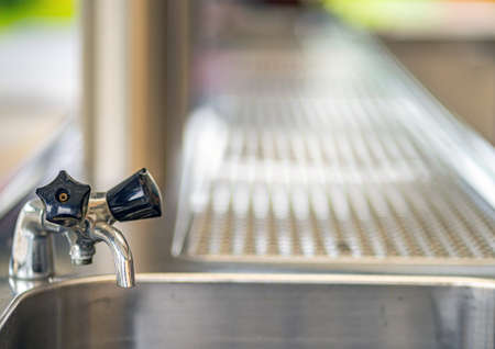 Faucet on a bar counter. Photographed in 2020