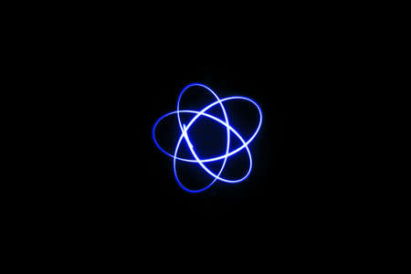 three blue orbit circle mixed light painting photography, long exposure, ripples and waves against a...