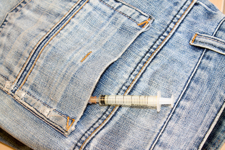 Syringes in a jeans pocketの写真素材