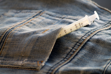 Syringes in a jeans pocketの写真素材