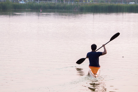 a man rowing in the canoeの写真素材