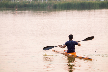 a man rowing in the canoeの写真素材