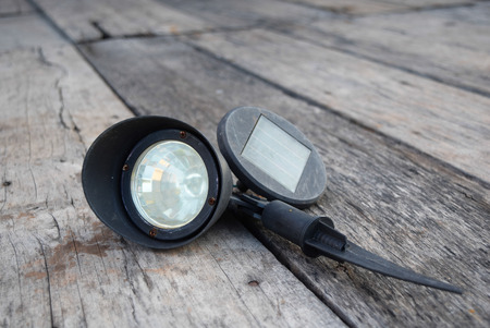 flashlight solar cell on woodの写真素材
