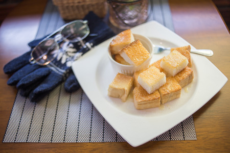 toast bread bake with honey on the plateの写真素材