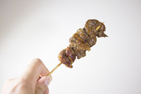 grilled meat on skewers is a street food in Thailandの写真素材