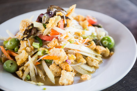 Som tum Thai is an incredibly popular Thai salad made of shredded green papaya.の写真素材