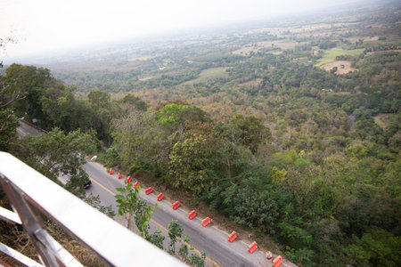 Mountain roads can vary greatly in size and complexity, from narrow dirt paths to multi-lane highways. They may be paved or unpaved, and may include features such as switchbacks, hairpin turns, and steep grades.の写真素材