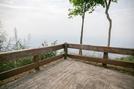 A photo of a wooden fence along a mountain pathの写真素材