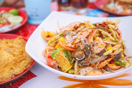 this Thai Papaya Salad recipe includes all the traditional ingredients like yard-long beans, tomatoes, chilies, and lime juice plus salted.の写真素材