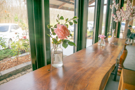 Rose in a glass jar on  the tableの写真素材