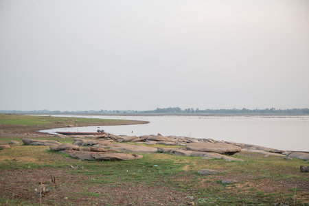 Pile of stones near the river during
sunsetの写真素材