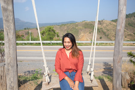 Smiling Woman On Swingの写真素材