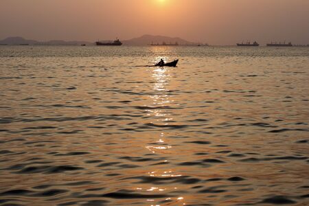 Little boat in the sea with sunset