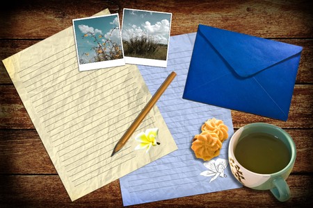 Letter with mail and tea on the wooden textureの写真素材