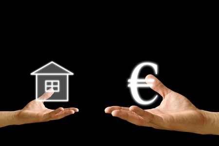 Small hand exchange house with Euro icon from the big handの写真素材