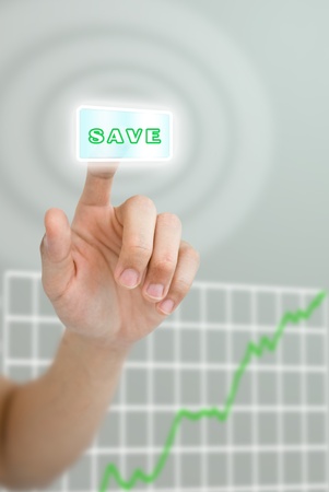 Hand pushing save button with grown up graph of stock marketの写真素材