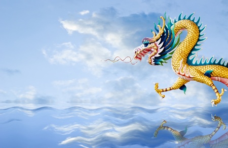 Golden dragon flying over the sea with nice sky background, Fantasy conceptの写真素材