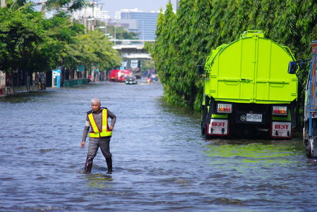 BANGKOK, THAILAND - NOV 7 : UNIDENTIFIED POLICEMAN WALKNG IN WATER FLOOD ON NOV 7, 2011 IN KAMPHAENG...