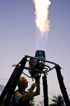 CHIANG MAI - NOV 26: Unidentified pilot testing burner of Hot air balloon during Thailand balloon festival 2011 at Prince Royal college in Chiang mai, Thailand on Nov 26, 2011.のeditorial素材