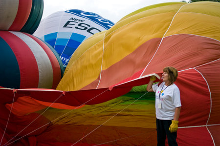 CHIANG MAI, THAILAND - NOV 26: Unidentified woman fill hot air in balloon during Thailand balloon festival 2011 at Prince Royal college in Chiangmai, Thailand on Nov 26, 2011.のeditorial素材